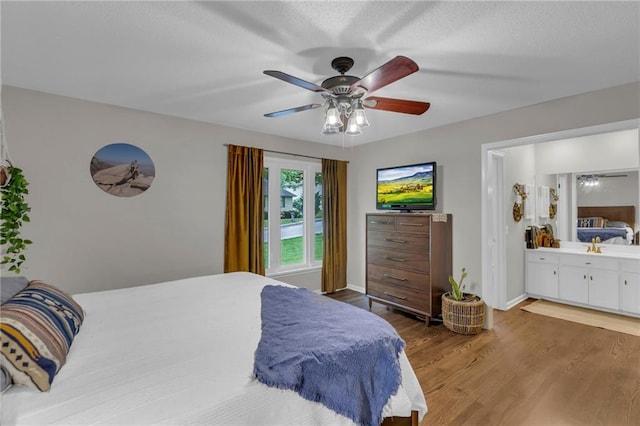 4212 NW Briarcliff Ln, Kansas City, MO 64116 - bedroom with light wood finished floors, a ceiling fan, ensuite bathroom, and baseboards