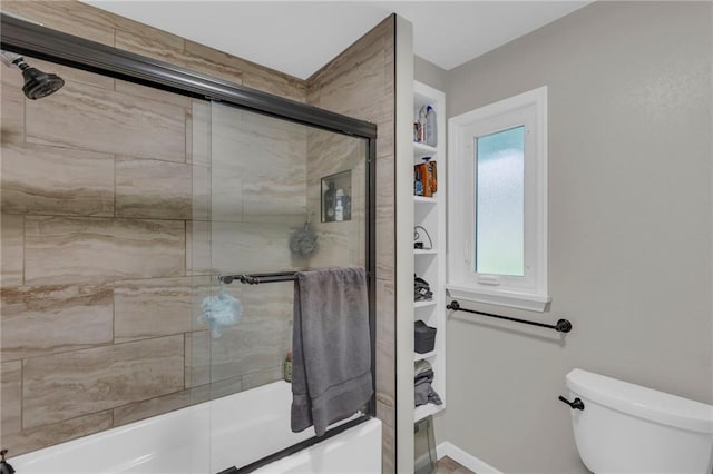 4212 NW Briarcliff Ln, Kansas City, MO 64116 - bathroom with toilet and shower / bath combination with glass door
