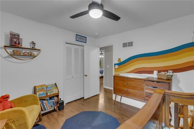 4212 NW Briarcliff Ln, Kansas City, MO 64116 - bedroom with wood finished floors, a closet, and a ceiling fan
