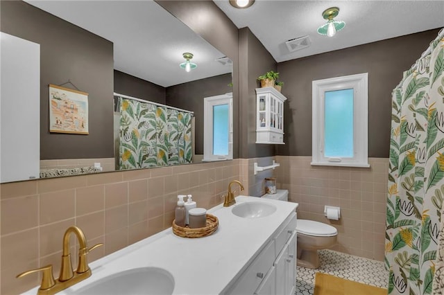 4212 NW Briarcliff Ln, Kansas City, MO 64116 - full bath with tile walls, toilet, tile patterned floors, healthy amount of natural light, and double vanity