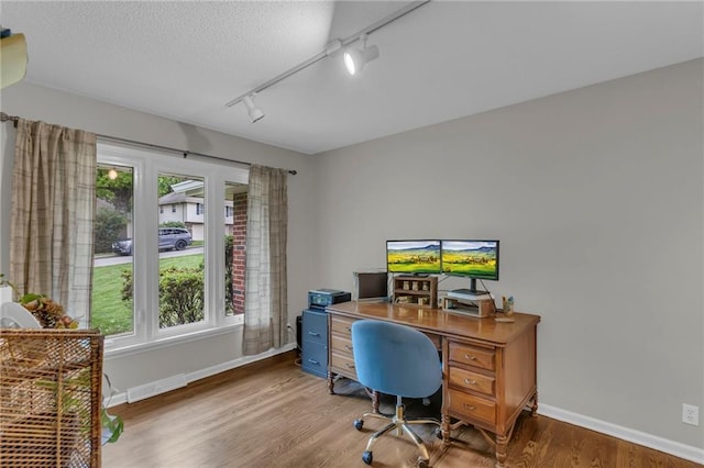 4212 NW Briarcliff Ln, Kansas City, MO 64116 - office with track lighting, baseboards, wood finished floors, and a textured ceiling