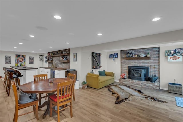 4212 NW Briarcliff Ln, Kansas City, MO 64116 - dining space with wet bar, light wood-style floors, recessed lighting, and baseboards