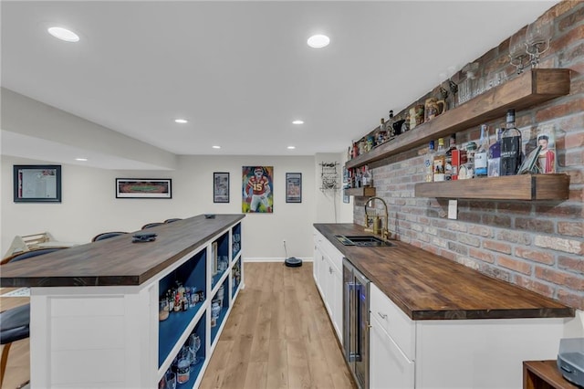 4212 NW Briarcliff Ln, Kansas City, MO 64116 - indoor wet bar with beverage cooler, baseboards, light wood finished floors, and recessed lighting