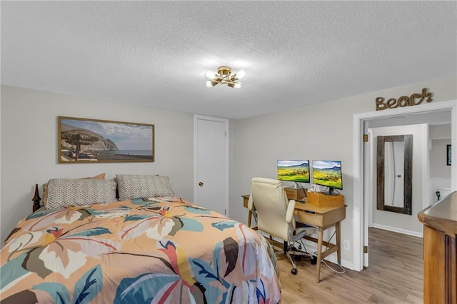 4212 NW Briarcliff Ln, Kansas City, MO 64116 - bedroom featuring light wood finished floors and a textured ceiling