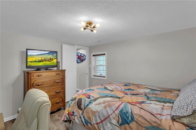 4212 NW Briarcliff Ln, Kansas City, MO 64116 - bedroom featuring light wood-type flooring and a textured ceiling