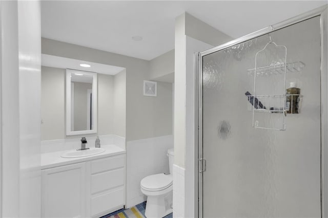 4212 NW Briarcliff Ln, Kansas City, MO 64116 - bathroom with toilet, a shower stall, vanity, recessed lighting, and a wainscoted wall
