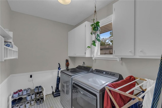 4212 NW Briarcliff Ln, Kansas City, MO 64116 - laundry room featuring washer and dryer, cabinet space, and baseboards