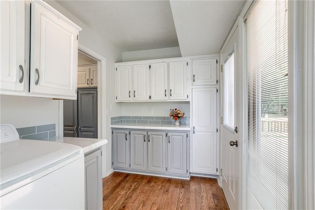 1209 NW Roanoke Dr, Blue Springs, MO 64015 - laundry room with washer / clothes dryer, cabinet space, and light wood finished floors