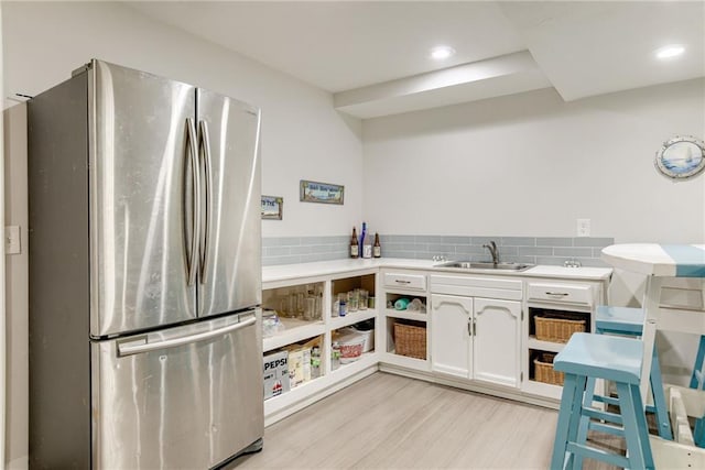 1209 NW Roanoke Dr, Blue Springs, MO 64015 - kitchen with freestanding refrigerator, white cabinets, light wood finished floors, open shelves, and recessed lighting