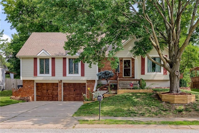 1209 NW Roanoke Dr, Blue Springs, MO 64015 - view of front facade featuring concrete driveway, an attached garage, and brick siding