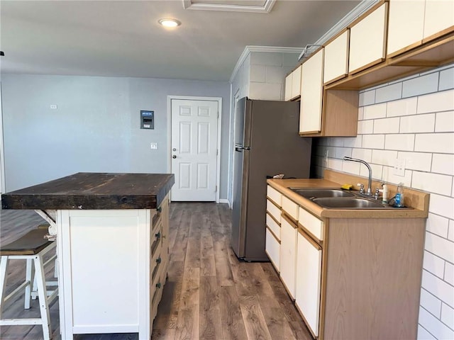 900 E 7th St, Galena, KS 66739 - kitchen featuring a sink, a center island, dark wood-style flooring, a kitchen breakfast bar, and tasteful backsplash