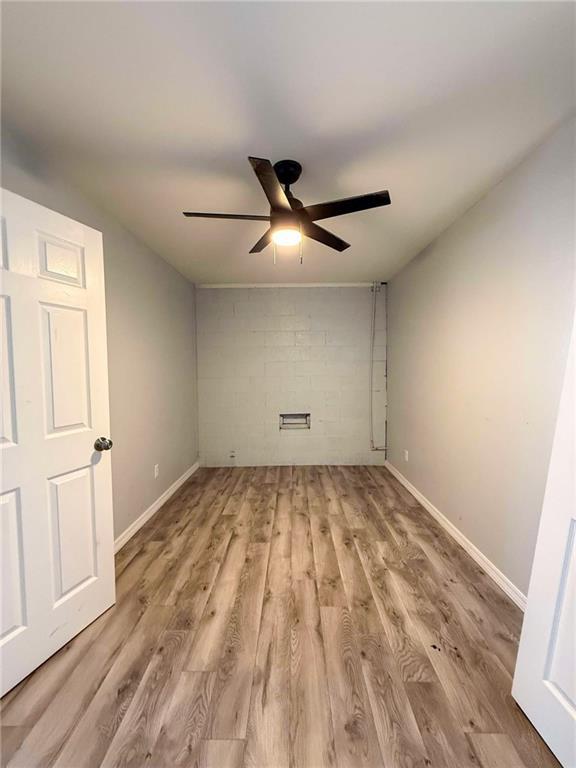 900 E 7th St, Galena, KS 66739 - empty room with ceiling fan, wood finished floors, and baseboards