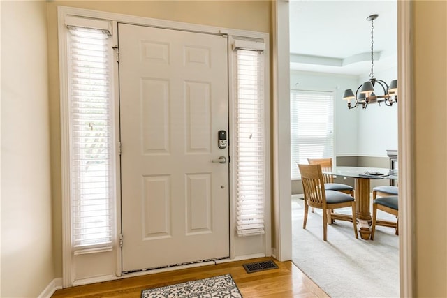 13238 Reeder St, Overland Park, KS 66213 - foyer featuring a chandelier and light wood finished floors