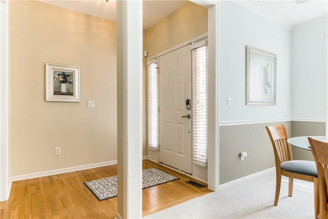 13238 Reeder St, Overland Park, KS 66213 - foyer entrance featuring wood finished floors, baseboards, and crown molding