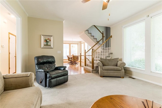 13238 Reeder St, Overland Park, KS 66213 - carpeted living area featuring stairway, crown molding, baseboards, and a ceiling fan