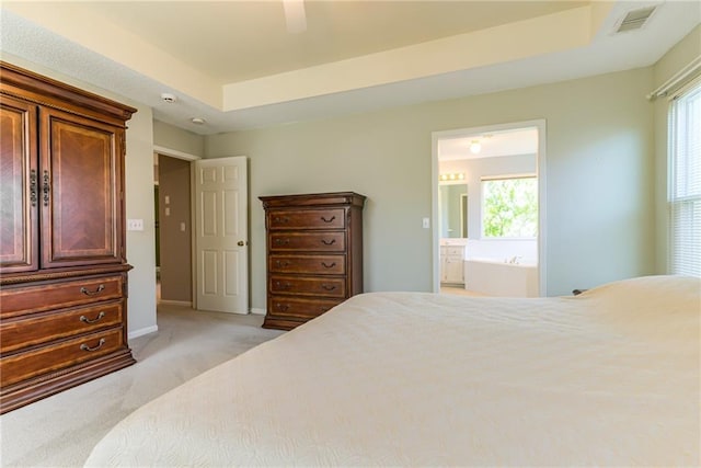 13238 Reeder St, Overland Park, KS 66213 - bedroom with light colored carpet, connected bathroom, ceiling fan, and a raised ceiling