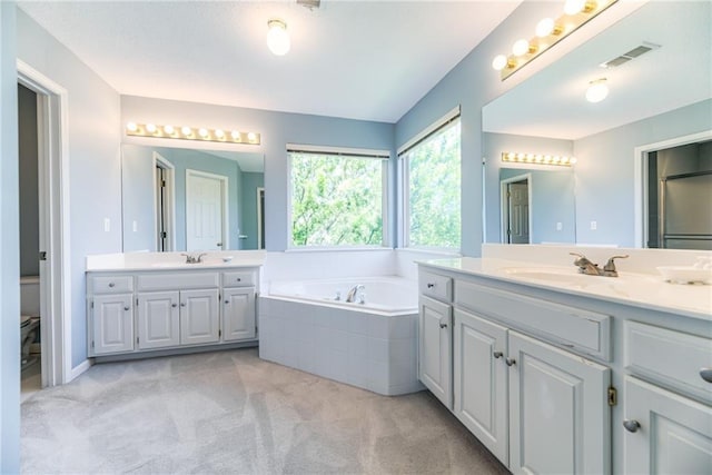 13238 Reeder St, Overland Park, KS 66213 - bathroom with a bath and two vanities