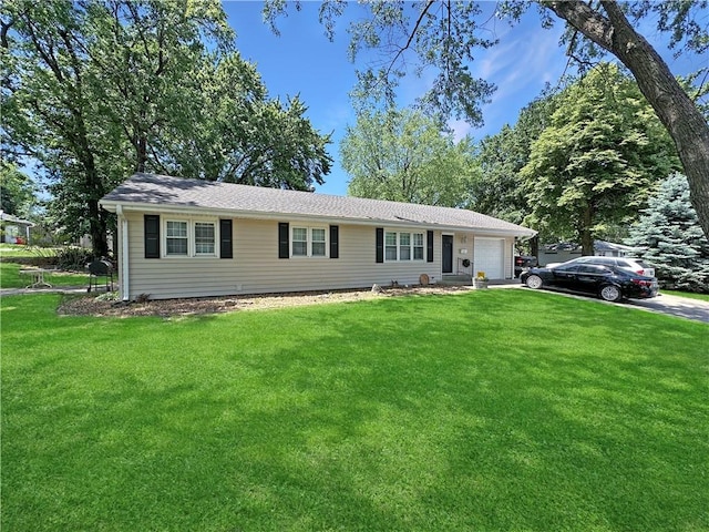 ranch-style home featuring an attached garage, a front lawn, and driveway