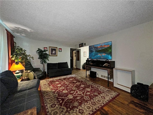 living area featuring a textured ceiling and wood finished floors