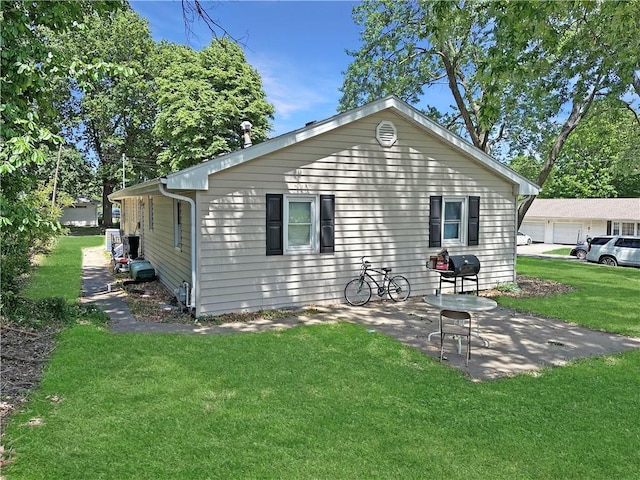 rear view of house with a yard and a patio