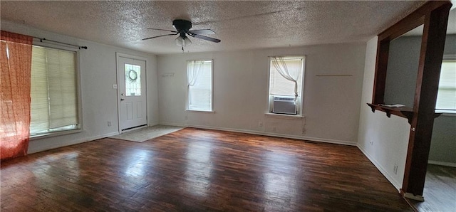 3118 Wallace Ave, Kansas City, MO 64129 - foyer entrance with wood finished floors, a ceiling fan, a textured ceiling, and cooling unit