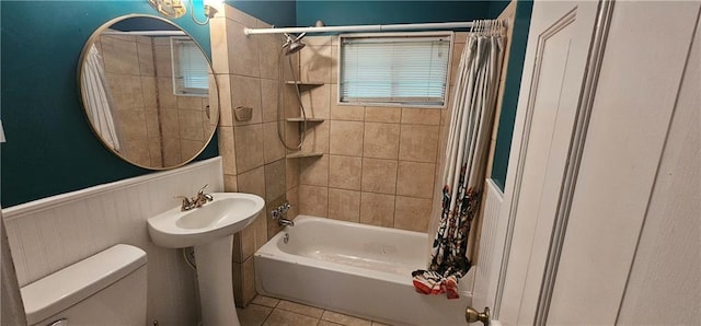 3118 Wallace Ave, Kansas City, MO 64129 - bathroom featuring wainscoting, shower / bath combo, and tile patterned flooring