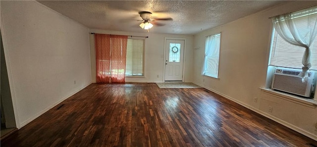3118 Wallace Ave, Kansas City, MO 64129 - entrance foyer with a textured ceiling, wood finished floors, a ceiling fan, and cooling unit