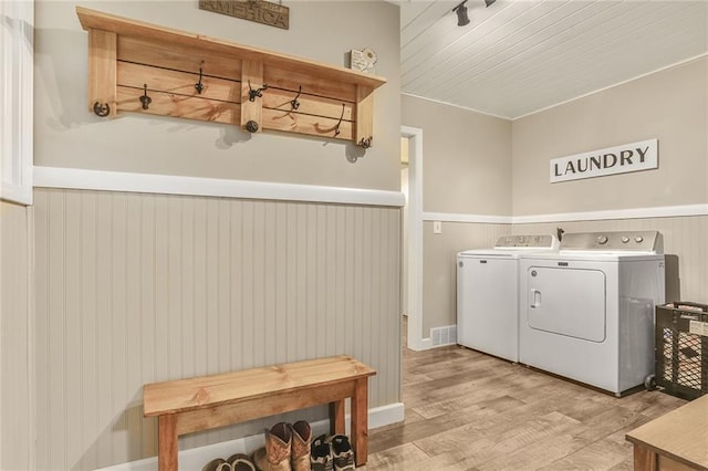 20440 147th St, Basehor, KS 66007 - laundry room with washer and clothes dryer, a wainscoted wall, and wood finished floors