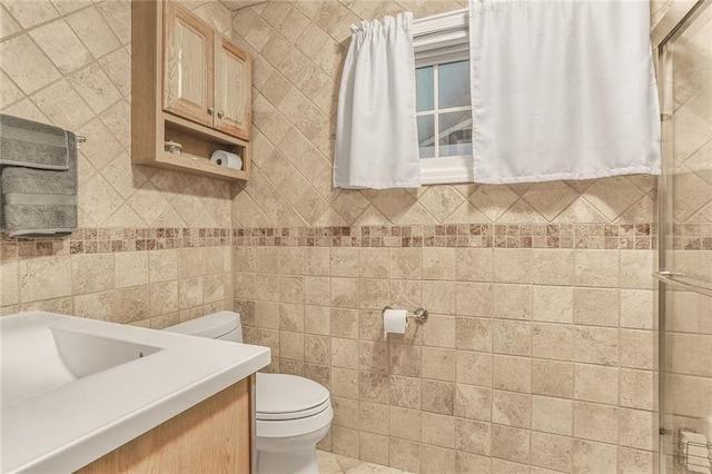 20440 147th St, Basehor, KS 66007 - bathroom with toilet, vanity, tile walls, and a shower with door