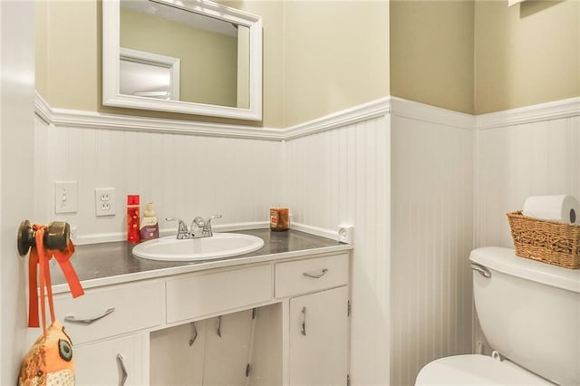 20440 147th St, Basehor, KS 66007 - bathroom featuring a wainscoted wall, toilet, and vanity