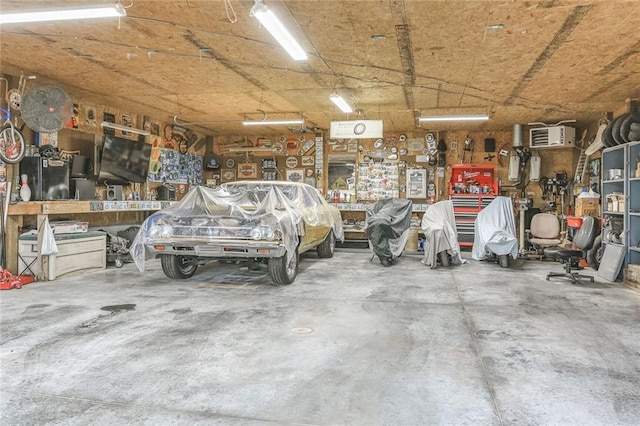 20440 147th St, Basehor, KS 66007 - garage with a workshop area and an AC wall unit