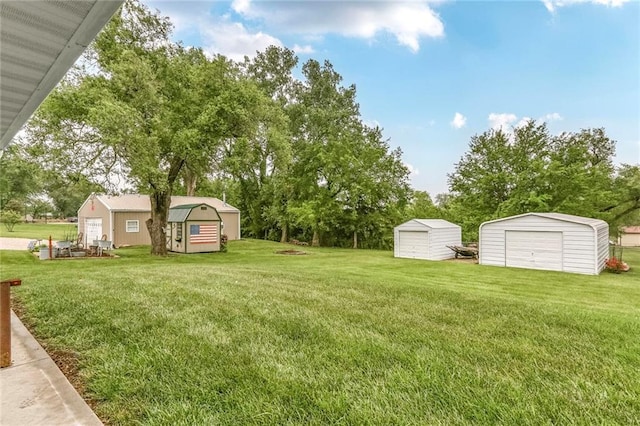 20440 147th St, Basehor, KS 66007 - view of grassy yard with a detached garage and view of wooded area