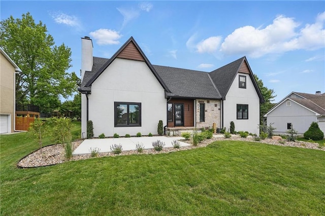 5263 SW Raintree Pkwy, Lees Summit, MO 64082 - view of front of home with a chimney, a front yard, a shingled roof, and stucco siding