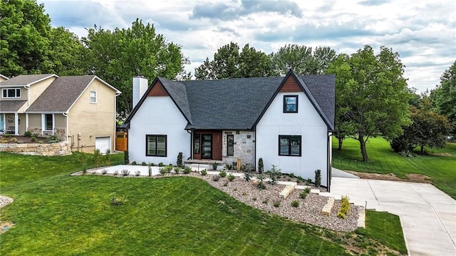 5263 SW Raintree Pkwy, Lees Summit, MO 64082 - view of front of property with a front yard, a chimney, a shingled roof, and stucco siding