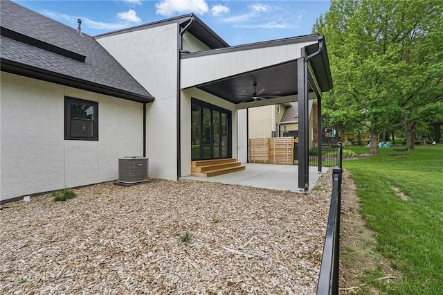 5263 SW Raintree Pkwy, Lees Summit, MO 64082 - back of house with a ceiling fan, a shingled roof, central air condition unit, stucco siding, and a patio