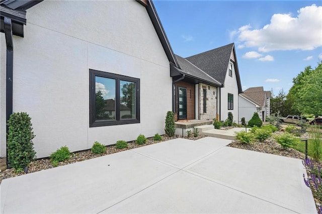 5263 SW Raintree Pkwy, Lees Summit, MO 64082 - view of home's exterior with stucco siding and a patio