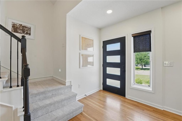 5263 SW Raintree Pkwy, Lees Summit, MO 64082 - foyer featuring stairway, wood finished floors, and baseboards