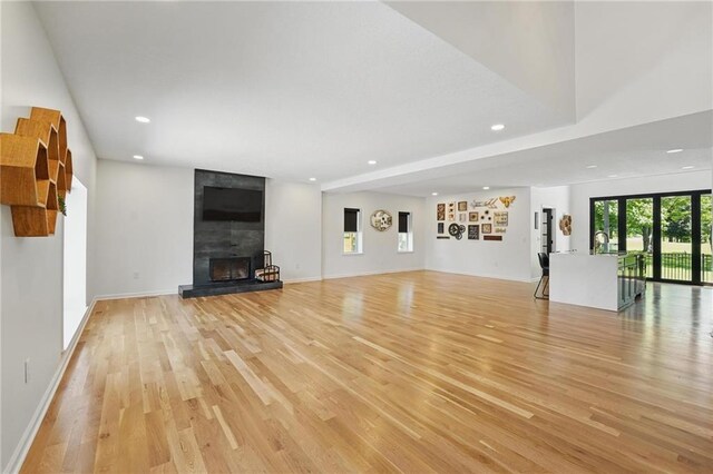 5263 SW Raintree Pkwy, Lees Summit, MO 64082 - unfurnished living room featuring light wood-style floors, recessed lighting, a fireplace, and baseboards