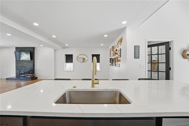 5263 SW Raintree Pkwy, Lees Summit, MO 64082 - kitchen with open floor plan, a sink, light stone counters, recessed lighting, and a center island with sink