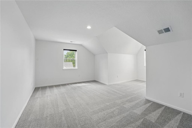 5263 SW Raintree Pkwy, Lees Summit, MO 64082 - additional living space with carpet floors, lofted ceiling, baseboards, and recessed lighting