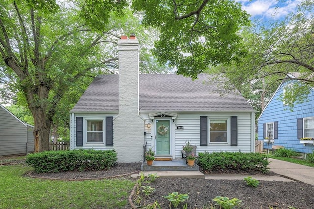 5608 Outlook St, Mission, KS 66202 - cape cod home with roof with shingles and a chimney