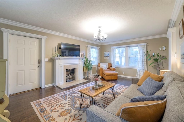 5608 Outlook St, Mission, KS 66202 - living room with ornamental molding, dark wood-type flooring, a chandelier, baseboards, and a fireplace with raised hearth