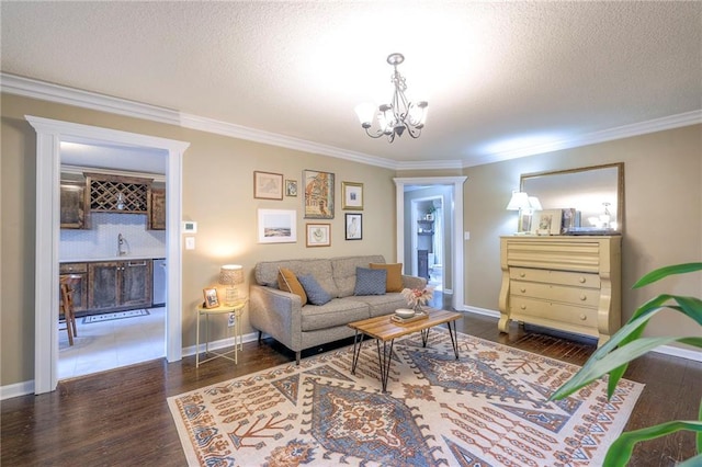 5608 Outlook St, Mission, KS 66202 - living area with ornamental molding, a chandelier, wood finished floors, a textured ceiling, and baseboards