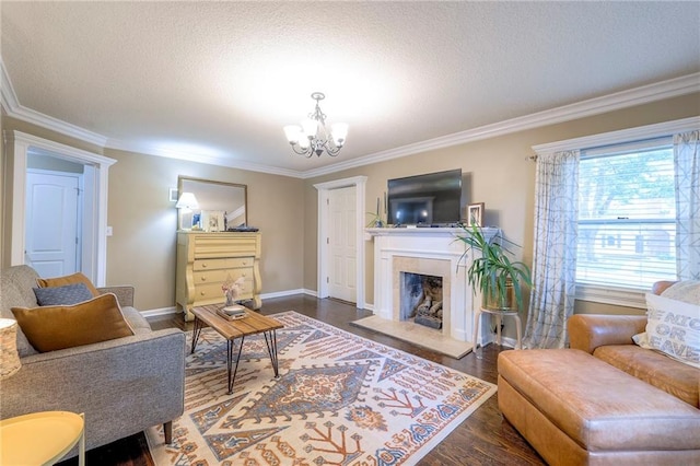 5608 Outlook St, Mission, KS 66202 - living area with a chandelier, ornamental molding, dark wood-type flooring, a textured ceiling, and a fireplace