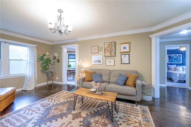 5608 Outlook St, Mission, KS 66202 - living area with a chandelier, crown molding, wood finished floors, and baseboards
