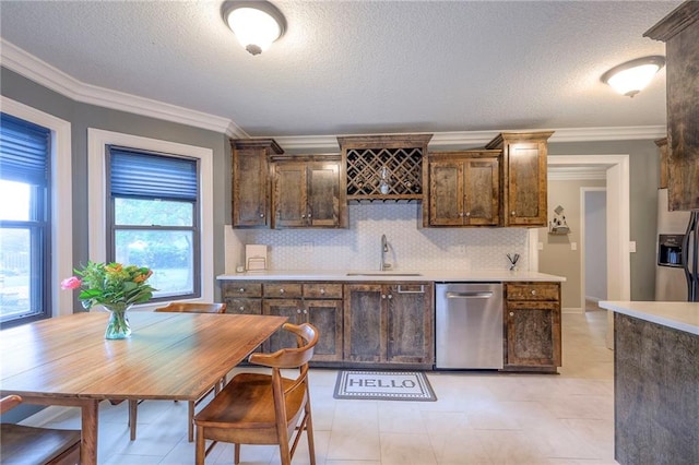 5608 Outlook St, Mission, KS 66202 - kitchen featuring appliances with stainless steel finishes, a sink, a textured ceiling, light countertops, and dark brown cabinetry