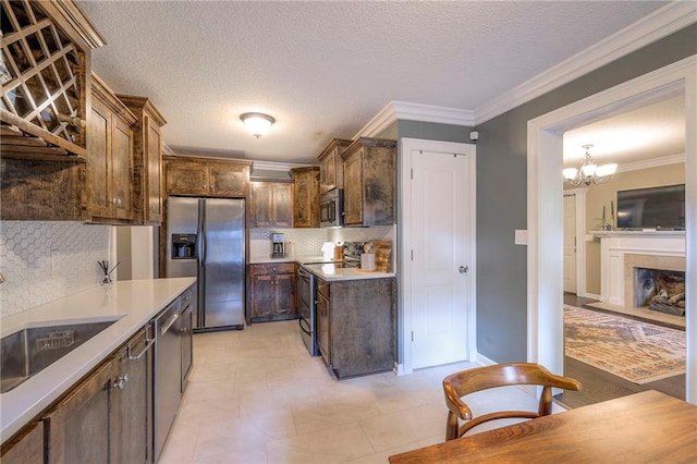 5608 Outlook St, Mission, KS 66202 - kitchen with stainless steel appliances, backsplash, dark brown cabinetry, a chandelier, and light countertops