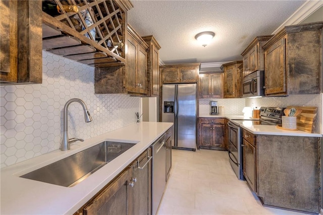 5608 Outlook St, Mission, KS 66202 - kitchen with appliances with stainless steel finishes, a sink, tasteful backsplash, light countertops, and a textured ceiling