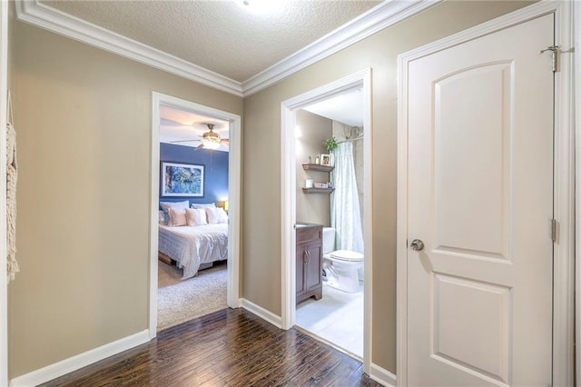 5608 Outlook St, Mission, KS 66202 - hallway with hardwood / wood-style floors, ornamental molding, a textured ceiling, and baseboards