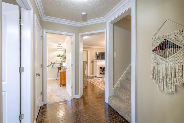 5608 Outlook St, Mission, KS 66202 - corridor with dark wood-style flooring, ornamental molding, stairway, baseboards, and a textured ceiling